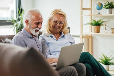A man and a woman looking at a laptop